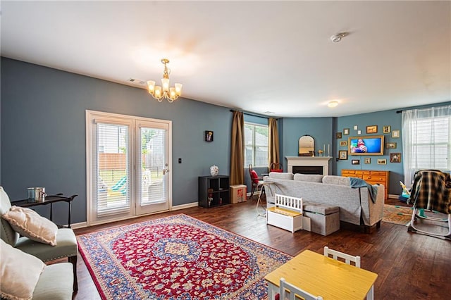 305 Thimbleberry Dr, Dawsonville, GA 30534 - living room with a chandelier, a fireplace, and wood finished floors