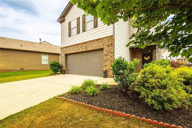 305 Thimbleberry Dr, Dawsonville, GA 30534 - traditional home with an attached garage, brick siding, and concrete driveway