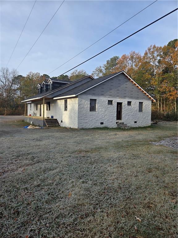 rear view of house with a yard