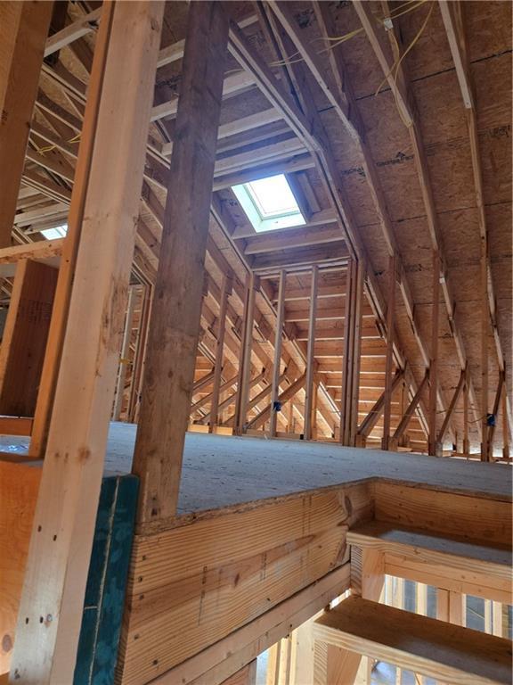 unfinished attic featuring a skylight