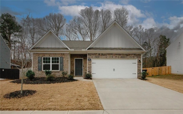 view of front of house with a garage, concrete driveway, fence, board and batten siding, and brick siding