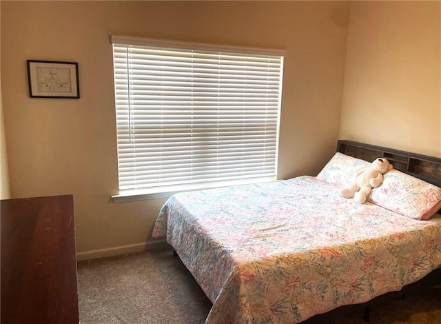 carpeted bedroom featuring baseboards