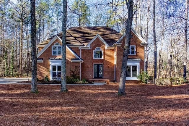 view of front of home featuring brick siding and french doors