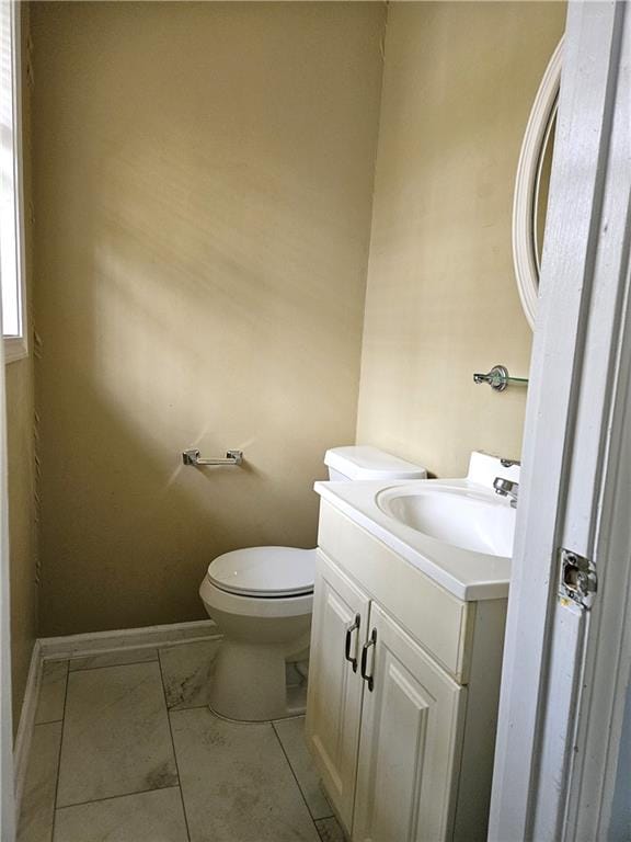 bathroom with tile patterned flooring, vanity, and toilet