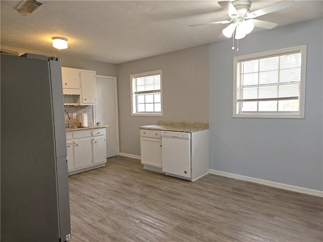 kitchen featuring white dishwasher, white cabinets, refrigerator, ceiling fan, and light hardwood / wood-style flooring