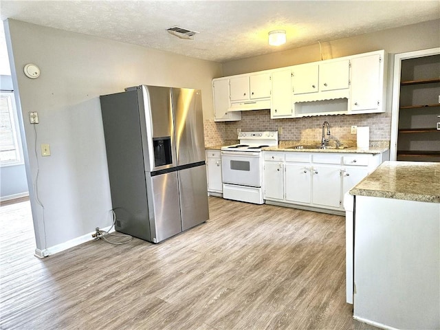 kitchen featuring light hardwood / wood-style floors, electric stove, white cabinets, stainless steel refrigerator with ice dispenser, and sink