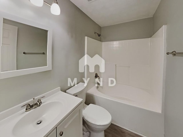 full bathroom featuring toilet, vanity, shower / washtub combination, and wood finished floors