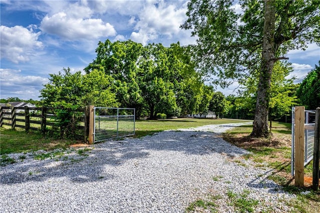 view of gate with a yard