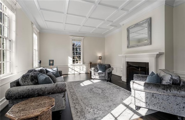 living room featuring dark wood-type flooring, crown molding, and coffered ceiling