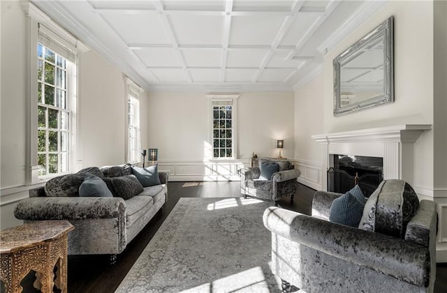 living room with coffered ceiling, dark wood-type flooring, and ornamental molding