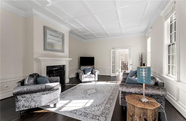 living room with coffered ceiling, crown molding, and hardwood / wood-style floors