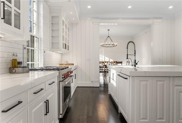 kitchen featuring decorative backsplash, white cabinetry, high end stainless steel range oven, and dark hardwood / wood-style floors