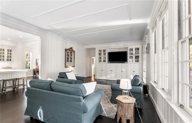 living room featuring built in features, ornamental molding, and dark hardwood / wood-style floors