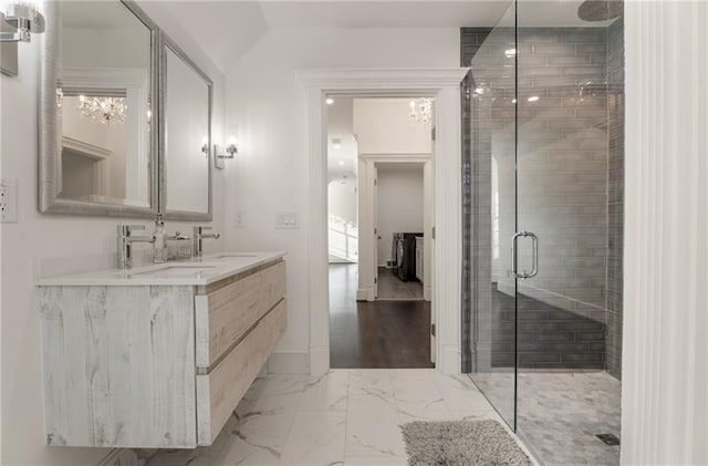 bathroom with hardwood / wood-style flooring, an enclosed shower, and dual vanity