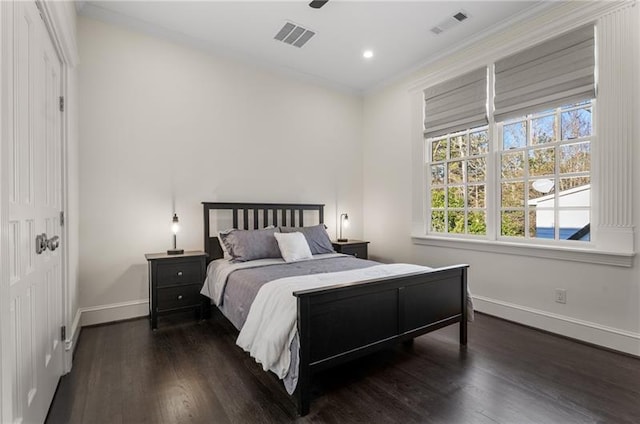 bedroom with ceiling fan, crown molding, and dark hardwood / wood-style floors