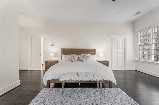 bedroom featuring crown molding and dark hardwood / wood-style floors