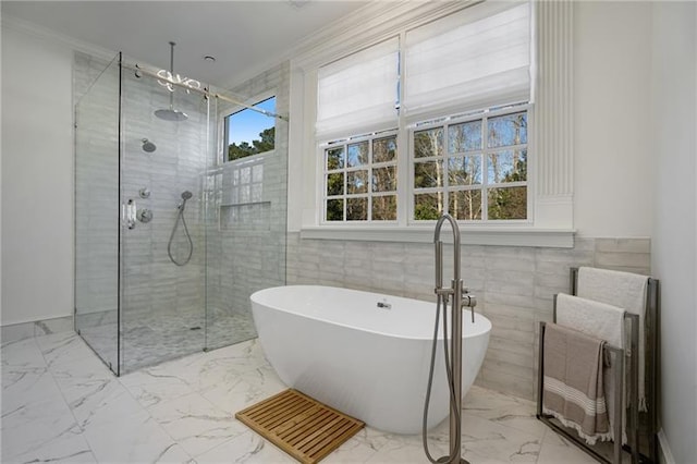 bathroom featuring tile walls, tile patterned floors, a healthy amount of sunlight, and ornamental molding