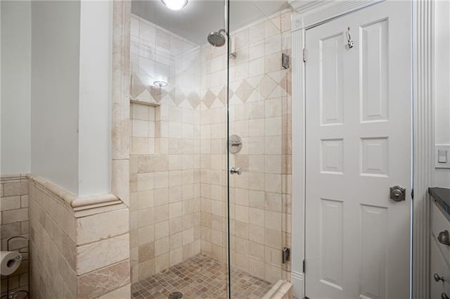 bathroom with a shower with door