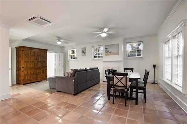 tiled dining area featuring ceiling fan and ornamental molding