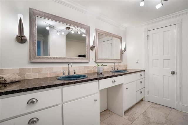 bathroom featuring rail lighting, crown molding, double vanity, and tile patterned flooring