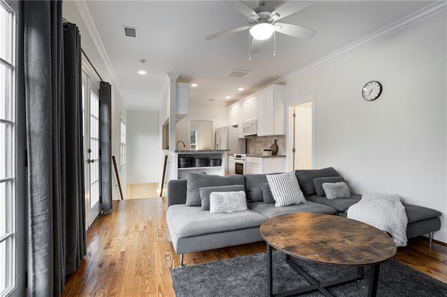 living room with plenty of natural light and wood-type flooring