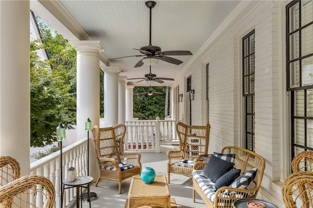 sunroom / solarium with ceiling fan and ornate columns