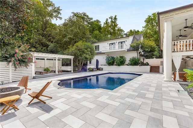 view of swimming pool with ceiling fan, an outdoor fire pit, a patio, and a pergola