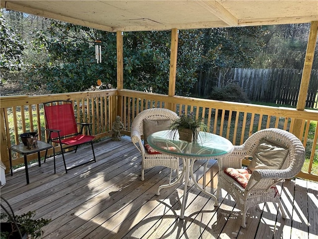 deck featuring outdoor dining area and fence