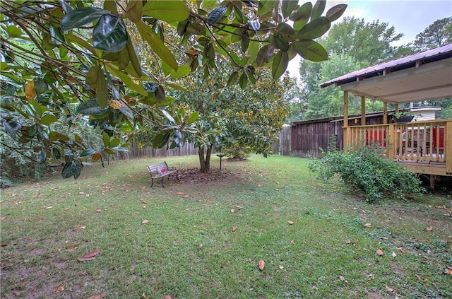 view of yard featuring a deck and fence