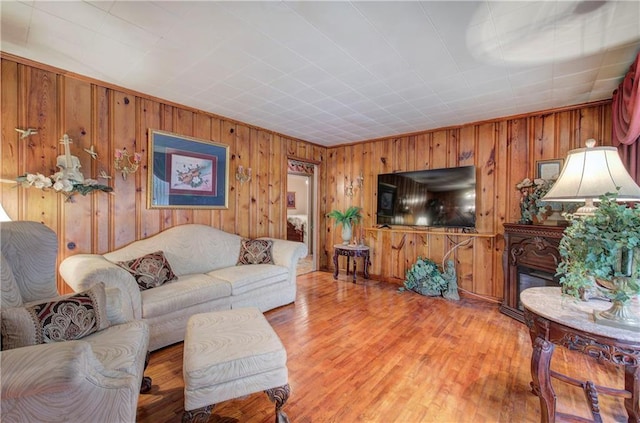 living area with wooden walls and light wood-style floors