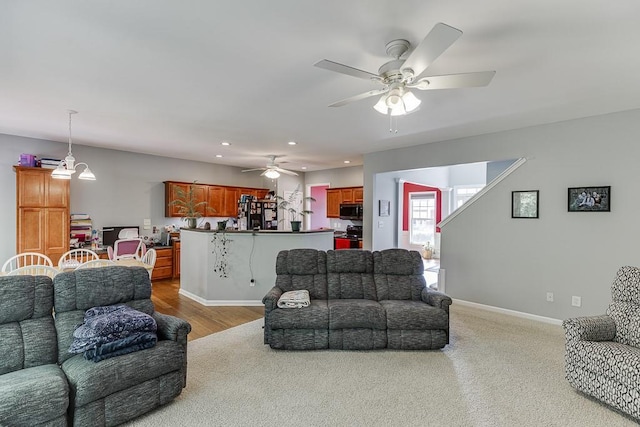 living area featuring recessed lighting, ceiling fan, and baseboards