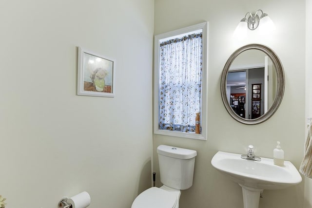 half bath with toilet and a sink