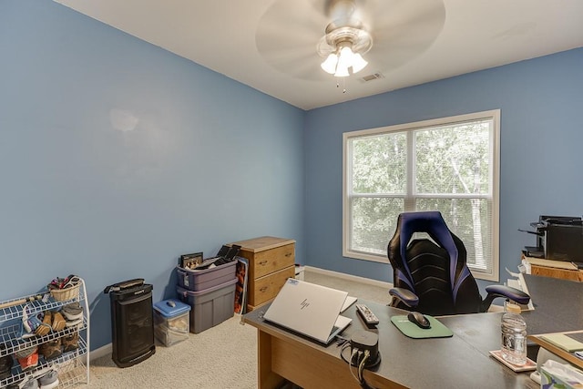 carpeted home office with a ceiling fan and baseboards