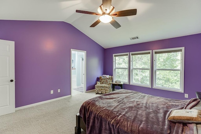 carpeted bedroom featuring lofted ceiling, baseboards, ensuite bath, and a ceiling fan