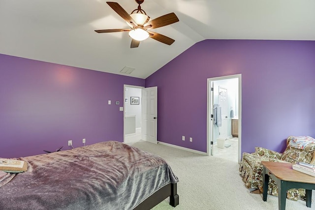 carpeted bedroom featuring vaulted ceiling, baseboards, ceiling fan, and ensuite bathroom