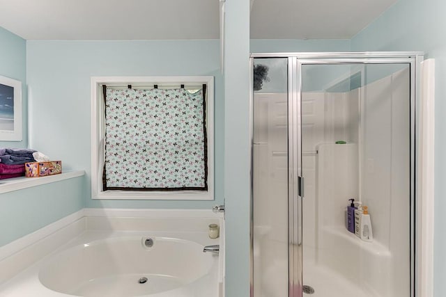 bathroom featuring a shower stall and a bath