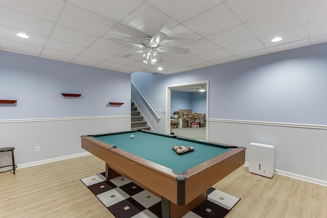 rec room with a ceiling fan, wood finished floors, billiards, baseboards, and a drop ceiling