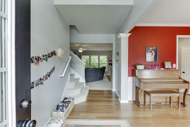 entrance foyer with wood finished floors, stairway, and a ceiling fan