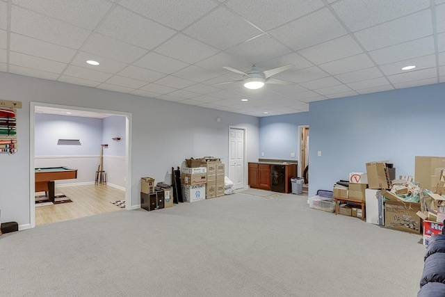 basement with ceiling fan, light carpet, pool table, baseboards, and a drop ceiling