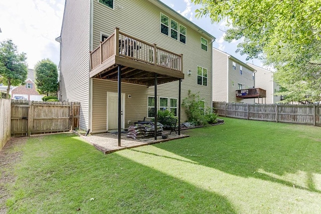 back of house with a deck and a patio