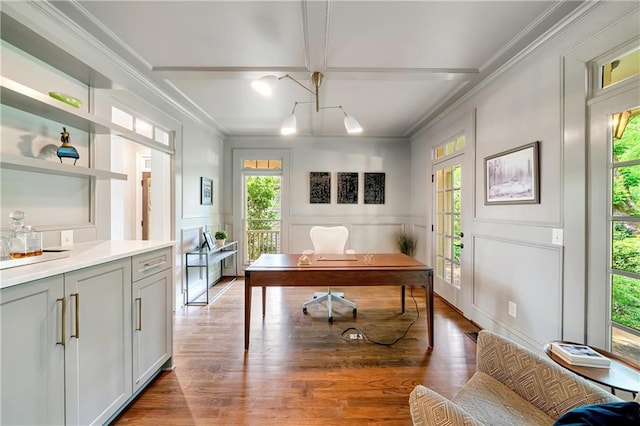 office area with a wealth of natural light, crown molding, and a decorative wall