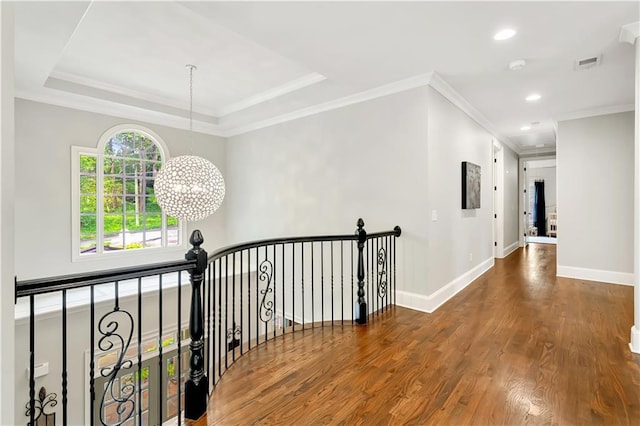 corridor featuring an upstairs landing, baseboards, recessed lighting, wood finished floors, and a notable chandelier