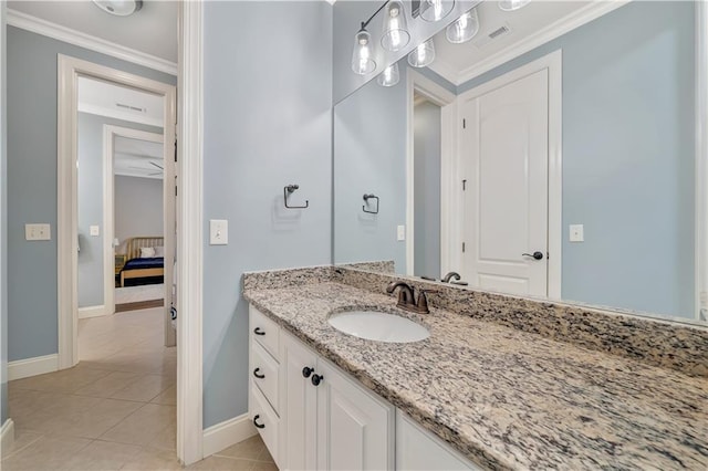bathroom featuring vanity, crown molding, tile patterned flooring, and baseboards