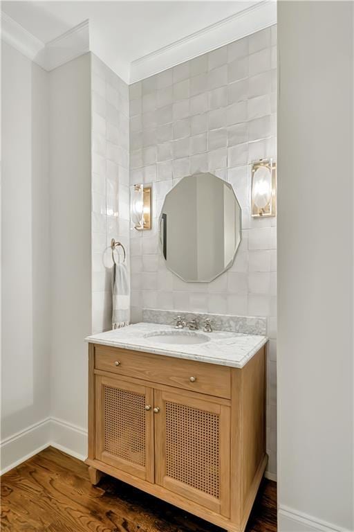 bathroom with baseboards, wood finished floors, and vanity