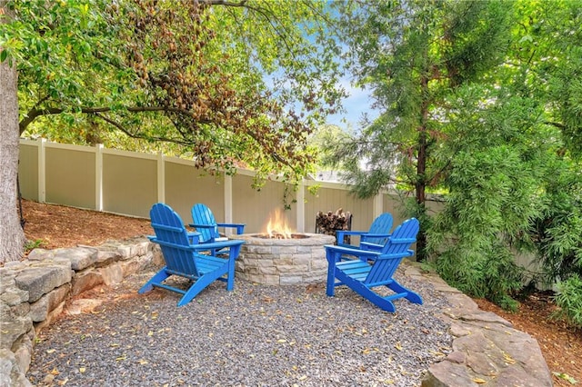 exterior space with a fire pit and fence