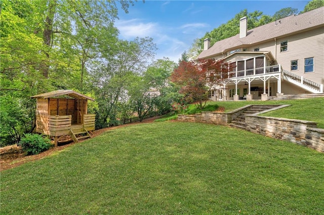 view of yard featuring a sunroom and stairway