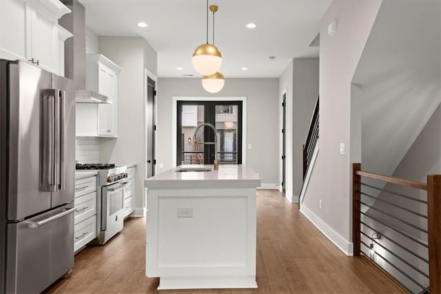 2329 Mason Dr Unit D24, Atlanta, GA 30316 - kitchen with high quality appliances, a sink, white cabinets, light countertops, and wall chimney range hood