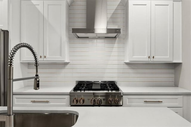 2329 Mason Dr Unit D24, Atlanta, GA 30316 - kitchen with wall chimney range hood, tasteful backsplash, light countertops, and white cabinetry