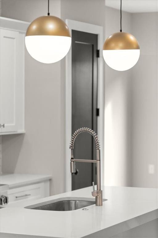 2329 Mason Dr Unit D24, Atlanta, GA 30316 - kitchen with a sink, white cabinetry, light countertops, and decorative light fixtures