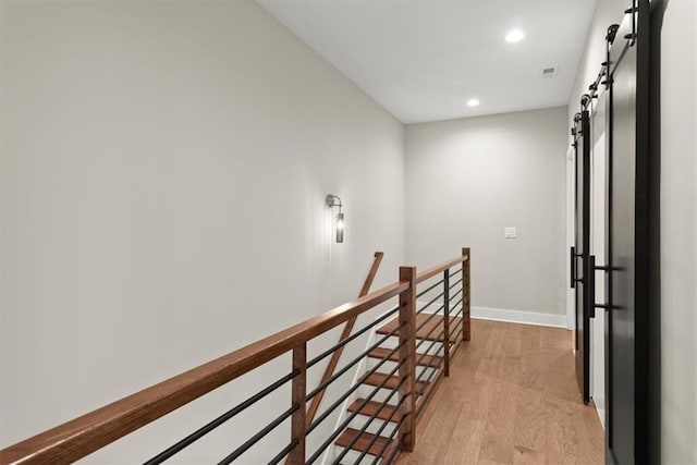 2329 Mason Dr Unit D24, Atlanta, GA 30316 - hallway featuring a barn door, an upstairs landing, light wood-style floors, recessed lighting, and baseboards